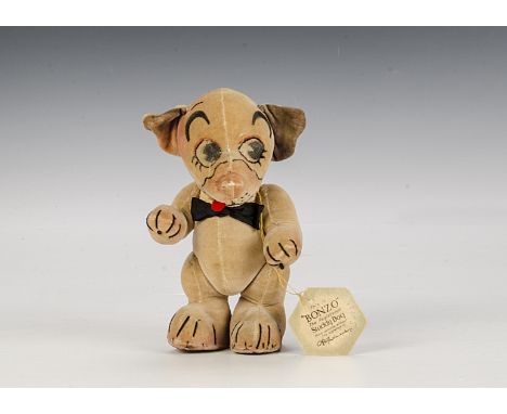 A Chad Valley side glancing Bonzo with card tag, late 1920s, of cream velvet, large painted side glancing eyes, red felt tong