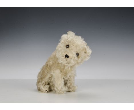 An unusual 1930s Steiff white mohair Molly dog, with large brown and black glass eyes, black stitched nose, mouth and claws, 