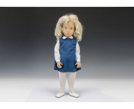 A Trendon Sasha doll Blonde Tunic, 115s, with blue dress, white blouse printed with blue flowers, white tights and shoes, wit