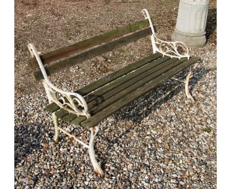 A white painted cast iron and teak garden bench , 122cm wide