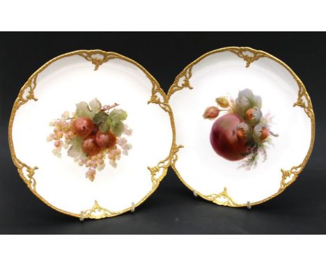 Two Berlin KPM porcelain cabinet plates, hand painted with central fruit design and ornate gilded borders, 22cm diameter each