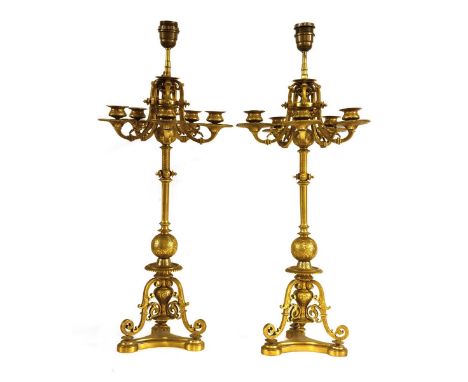 A pair of ormolu table lights, each in the form of six-light candelabra with scrolling decoration, on scrolling legs and a tr