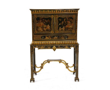 A Chinese Chippendale-style black lacquered chinoiserie cabinet on stand, with two doors over a single drawer, the stand with