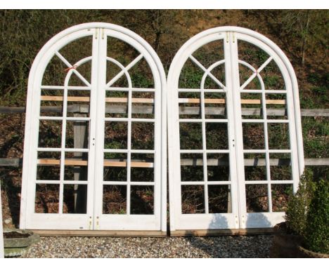 Two pairs of large white painted arch top doors, in frames, 155cm x 243cm overall