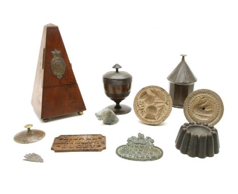 Butter moulds, jelly mould, tin box, treen pot and cover, two cast labels, and a metronome