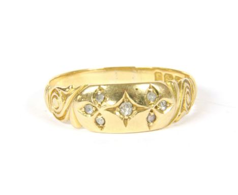 An 18ct gold diamond ring, an old cut diamond star set between two shamrock leaves, set with eight cut diamonds, scrolling sh