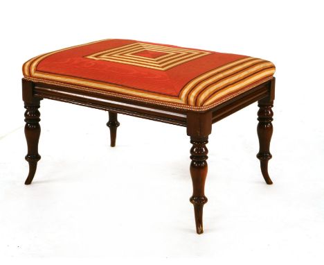 A mahogany dressing stool, 19th century, the silk upholstered seat on outswept ring-turned legs, 67 x 50 x 42cm