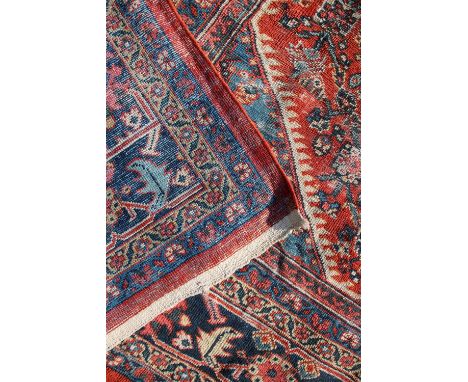 A caucasian floral decorated carpet, the red ground within multiple borders, 355 cm wide x 230 cm deep