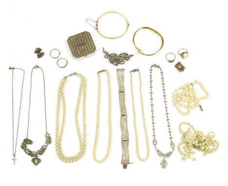A silver five row cobra link bracelet, claw set with three rows of circular cut rubies, a rolled gold hinge bangle, a single 