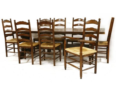 A farmhouse table, with a burr top and a set of eight oak ladder back chairs with rush seats (6 + 2), 244cm wide x 91 deep x 