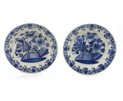 Two Delftware blue and white chargers , painted with flowers,. 34cm diam.