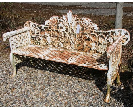A cast iron white painted garden bench, the interlocked leaf decorated back above geometric pierced diamond seat on scrolled 