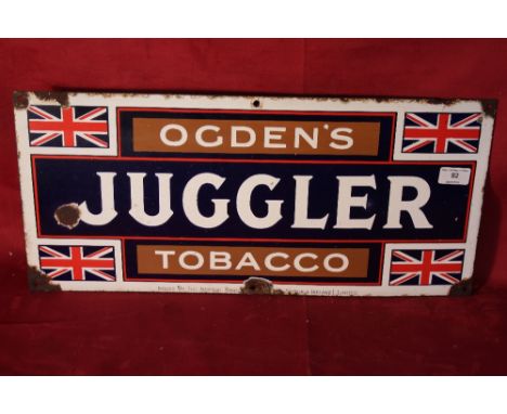 A vintage enamel "Ogden's Juggler Tobacco" sign, 10" x 22"