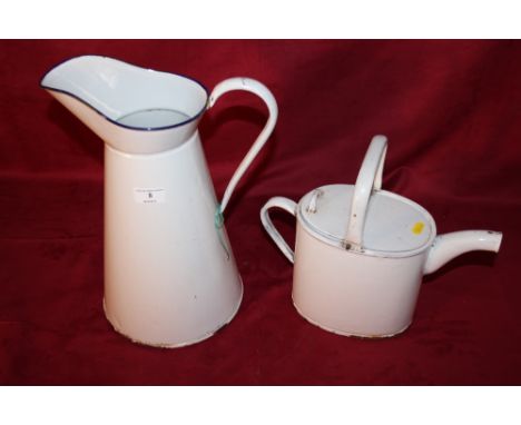 An antique enamel water can and a similar jug
