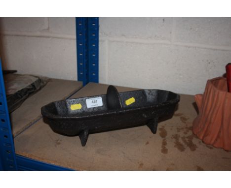 A small cast iron two division feeding trough 