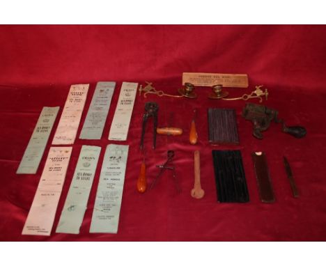 A box containing various small tools; a pair of brass piano candle holders; a quantity of vintage sea hooks etc.