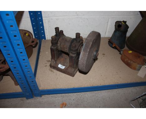 An old iron ornate grind stone for a stationery engine 