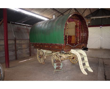 A vintage gypsy wagon with interior fitments and accessories including enamel stove, steps etc. (In need of some restoration)