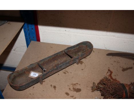 A small vintage cast iron feeding trough 