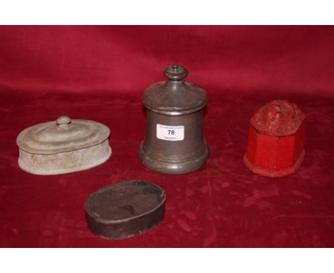 An antique pewter tobacco jar; a cast iron similar; an oval lead example and a pewter snuff box