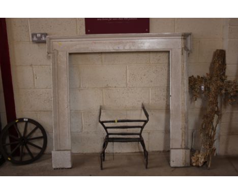 An antique painted pine fire surround and a wrought iron grate