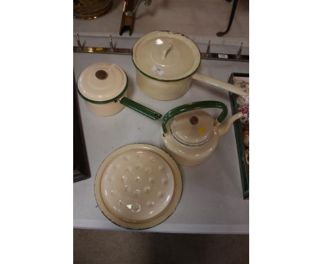 An enamel kettle; two saucepans and a casserole dish