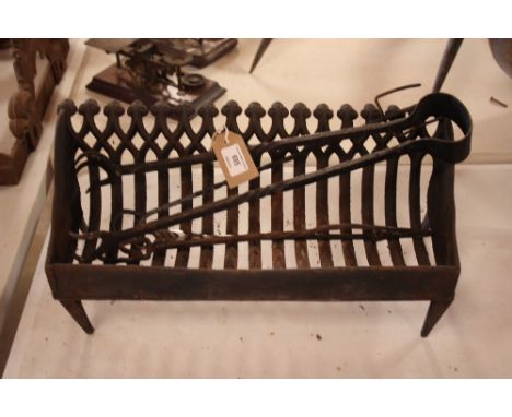 An old cast iron fire grate and various tools