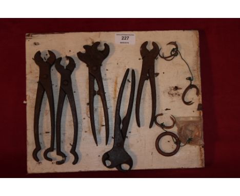 A quantity of pig ringing tools on a small board 