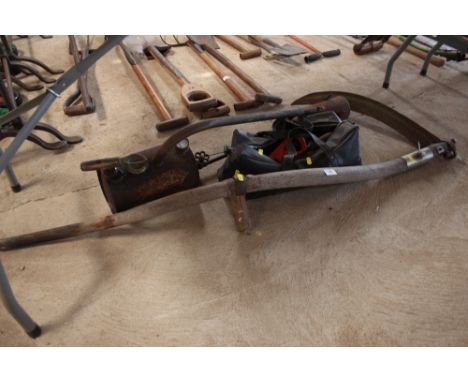 An old wooden scythe; a vintage flame thrower and a bag of various tools etc.