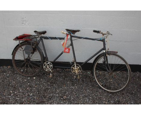 A vintage tandem bicycle with child seat