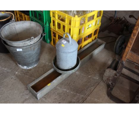 A galvanised chicken drinker and a trough 