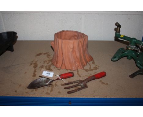 A small vintage trowel and fork and a terracotta planter