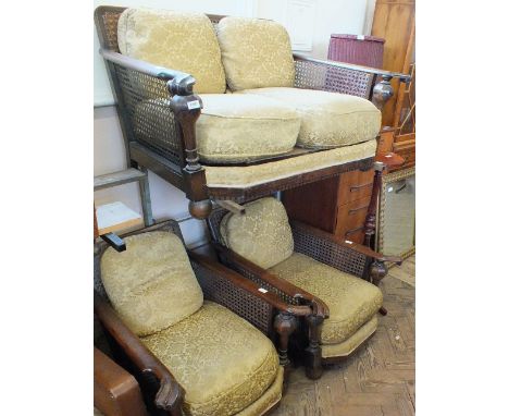 A Bergere oak framed two seat sofa and chairs with carved arms