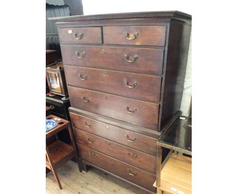 A Georgian oak chest on chest, the top having two short and three long drawers and base with three drawers, all with brass sw