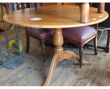 A Victorian pine dining table on tripod base