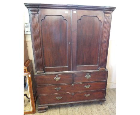 An early 19th Century mahogany frame linen press with two short and two long drawers, original handles on ogee bracket feet