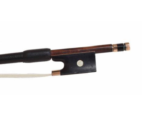 Gold mounted violin bow by and stamped Conrad Glaesel, Bruxelles, the stick round, the ebony frog inlaid with pearl eyes and 