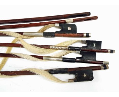 Four various bows with broken sticks, two stamped Paesold and Penzel, the other two illegibly stamped; also a violin bow stic