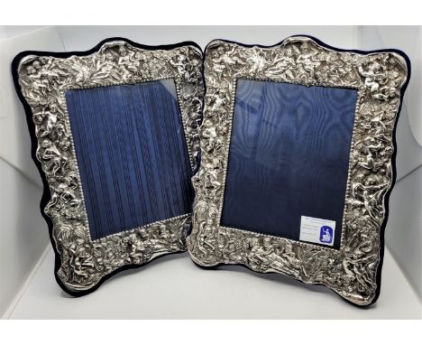 A pair of Britannia standard silver easel back photograph frames, by GMG, London 1997 and 1998, of rectangular form and in th