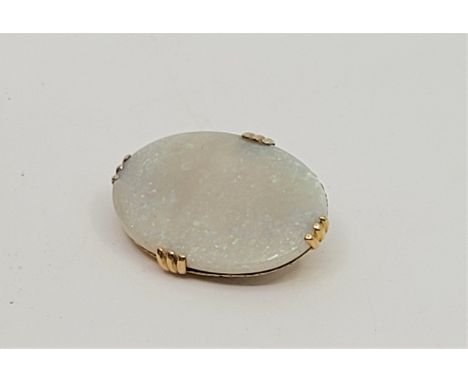 A 14ct. gold and opal oval pendant/brooch, set oval cabochon opal, 34mm x 24mm. (gross weight 7.4g)