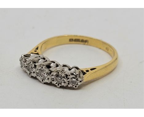 An 18ct. gold five stone diamond ring,&nbsp;Illusion set five graduated round brilliant cut diamonds (ETDW 0.17 carats), size