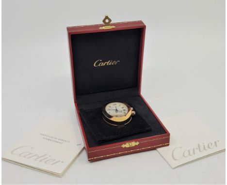 A Cartier gold plated desktop or nightstand oval quartz 2752 travel alarm clock, c.2006, having signed oval Roman numeral dia