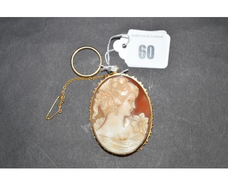 A carved shell cameo in rub over yellow metal mount; together with a 9ct. yellow gold wedding band, ring size N.