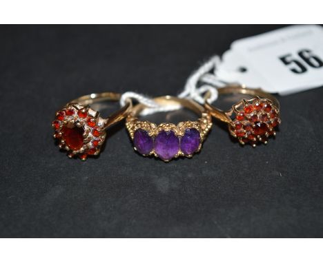 An amethyst ring, in Victorian style setting, ring size K; together with two garnet cluster rings, on 9ct. yellow gold shanks