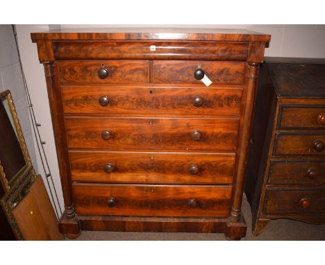 A Victorian mahogany scotch chest of five long and two short drawers fitted turned wooden handles, flanked by turned columns,