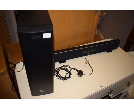 A Roth TV sound system, comprising: a sound bar, a large speaker and a remote control.