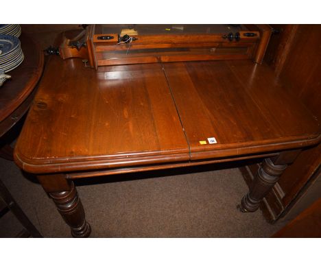 A Victorian rectangular mahogany telescopic extending dining table with spare leaf, raised on turned legs terminating in cera