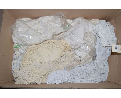 A box containing table lace; doilies; etc.