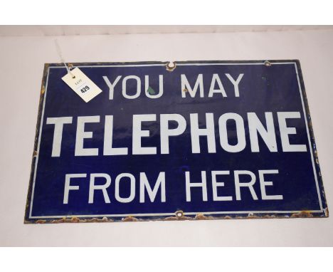 A vintage rectangular enamel sign inscribed 'You may telephone from here', in white lettering on dark blue ground.