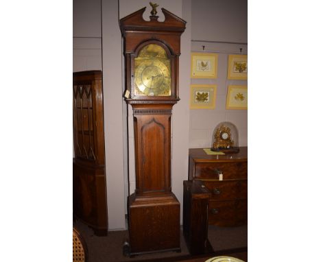 A 19th Century longcase clock in oak case, the pediment with ball and eagle finial, over an arched glazed panel door enclosin